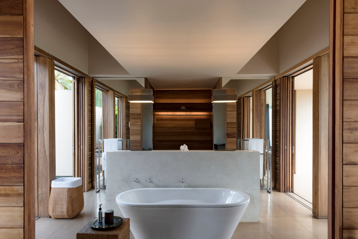 Modern bathroom with a freestanding bathtub, wooden walls, and large windows.