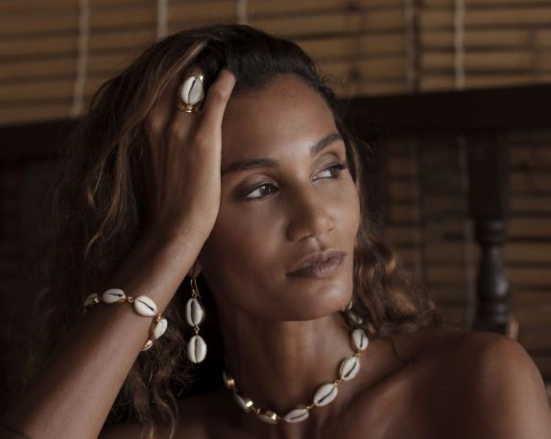 Woman wearing shell jewelry in a natural decor in Bali