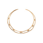 Gold and shell collar necklace on a white background
