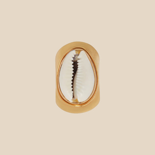 Gold cocktail ring with a shell design on a white background