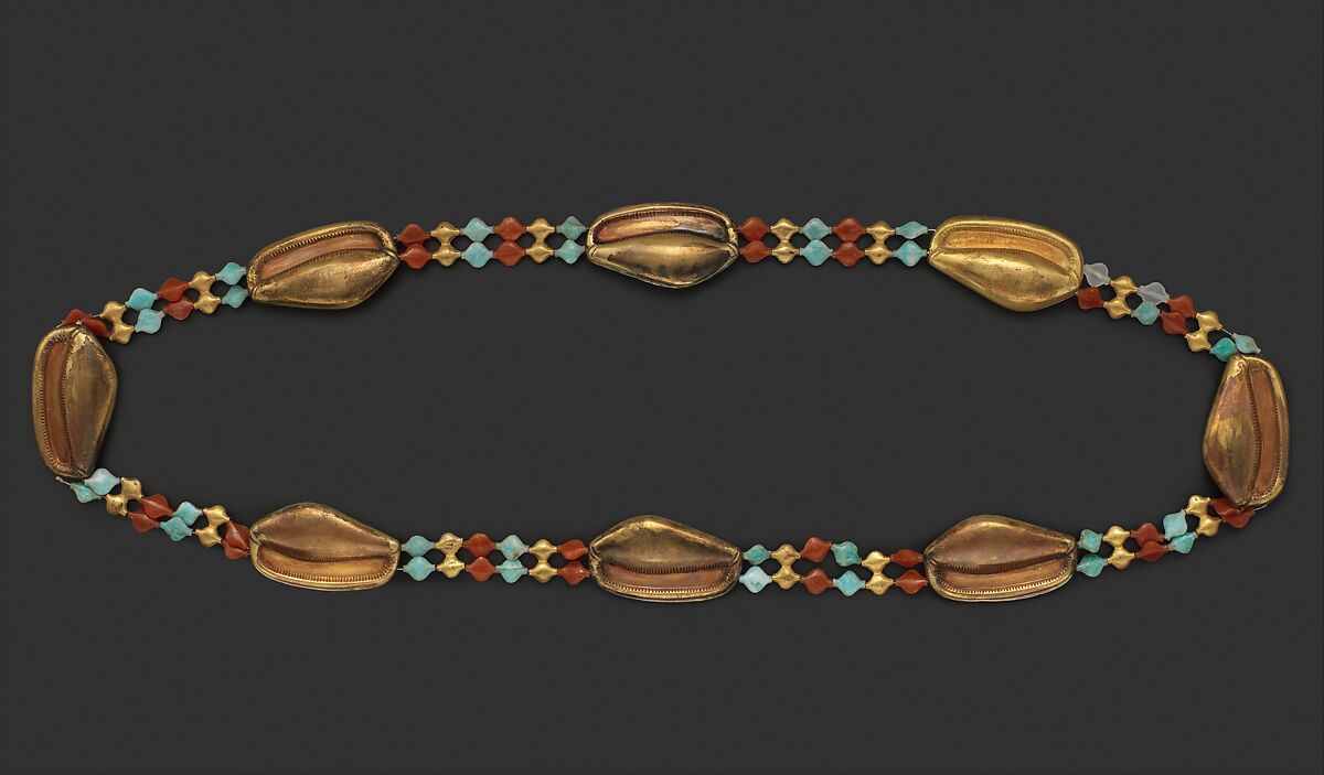 A gold cowrie shell girdle of the Egyptian Middle Kingdom with colourd beads inbetween the shells