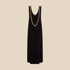 Black sleeveless dress with brown shell detail on a white background